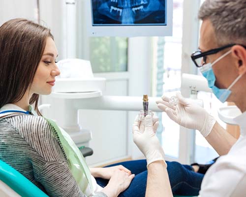 dentist explaining dental implant to patient