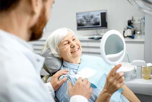 patient smiling after getting dental implants in Bedford