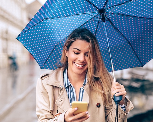 Smiling woman under an umbrella