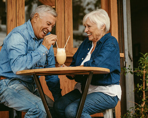 senior couple sharing a milkshake