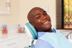 man smiling and enjoying the benefits of tooth-colored fillings with a dentist in Bedford