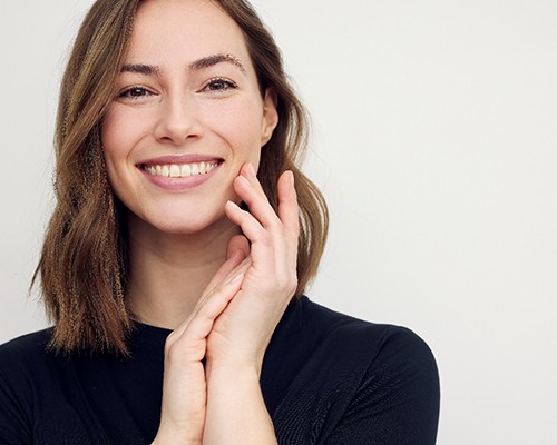 woman smiling about the cost of cosmetic dentistry in Bedford