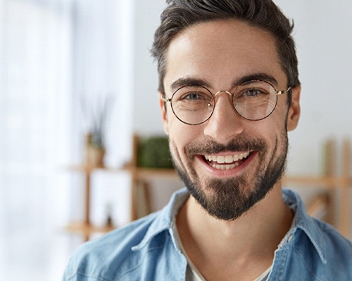 Smiling man with dental crowns in Bedford