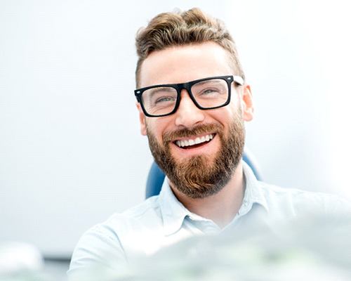 man smiling after getting dental crown