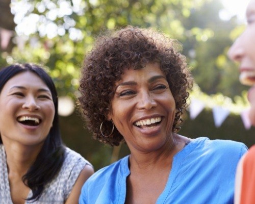 Friends outdoor smiling after dental implant tooth replacement