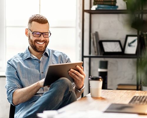 Man reviewing dental insurance forms on tablet computer