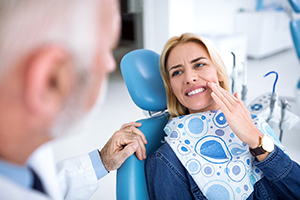 Woman with toothache in Bedford listening to a dentist