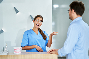 Dental employee explaining dental insurance coverage to patient