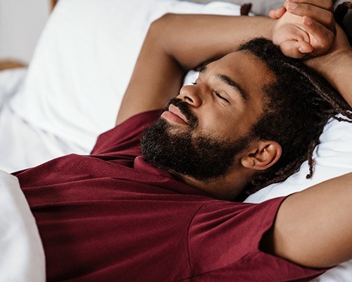 man resting after tooth extractions in Bedford