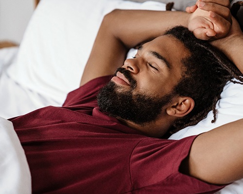 man resting after tooth extractions in Bedford 