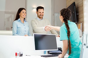 man shaking hands with dental team member