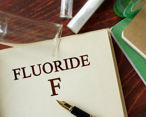 Open book with the word “fluoride” and an “F” printed on the page