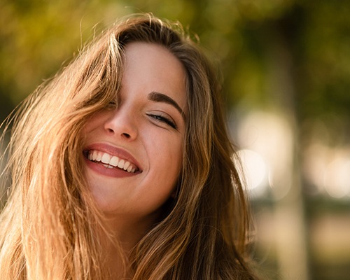 Woman smiling after gum recontouring in Bedford