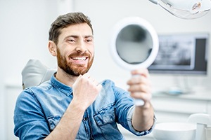 man admiring his smile in the mirror