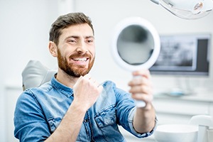 man admiring his smile in the mirror 