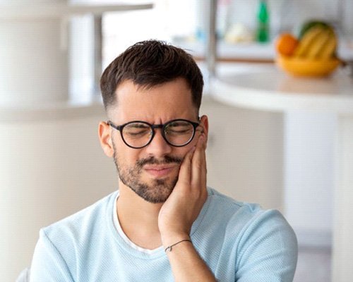 Man suffering from mouth pain