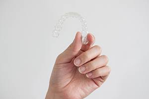 Patient holding clear aligner