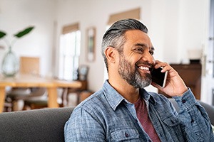 Man smiling while talking on phone