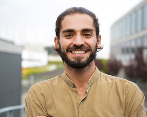 smiling man standing outside