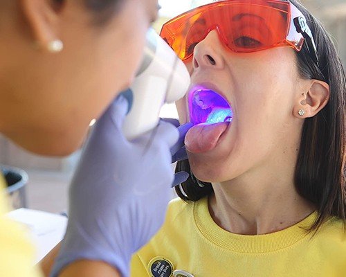 Dentist performing oral cancer screening