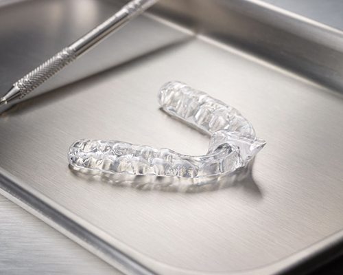 Clear nightguard for teeth grinding and T M J treatment on metal tray