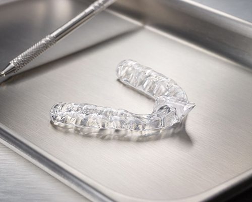Clear nightguard for teeth grinding on metal tray