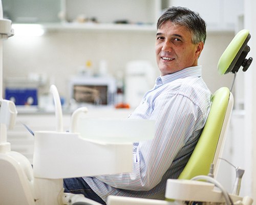 Male dental patient in chair after full mouth reconstruction in Bedford, TX