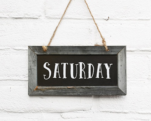 Closeup of Saturday sign hanging on wall