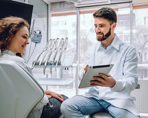 Dentist reviewing paperwork with patient