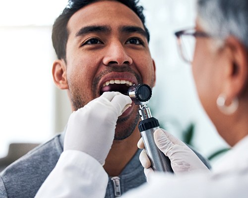 Man having his mouth examined