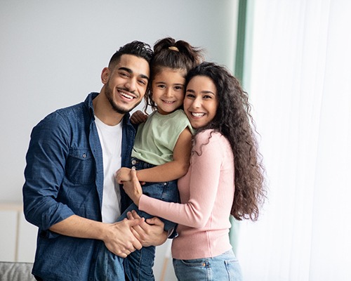 Happy parents posing with their little girl