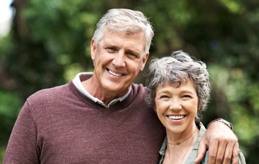 Man and woman sharing smiles after restorative dentistry