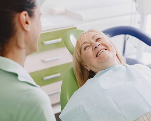 Patient and dental team member conversing