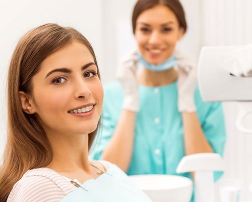 Woman with braces in dental treatment chair