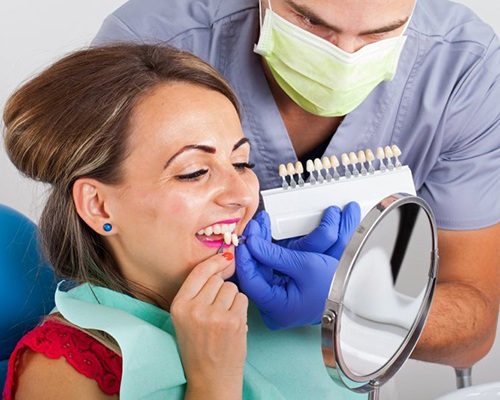 woman in dental chair trying on veneers in Bedford
