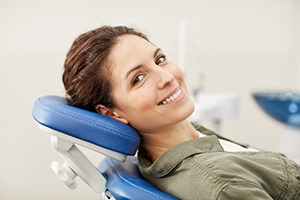 Woman smiling in dental chair while looking at camera