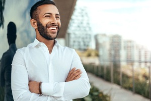 Man smiling with arms folded after teeth whitening in Bedford, TX