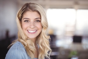 Young woman smiling after teeth whitening in Bedford, TX