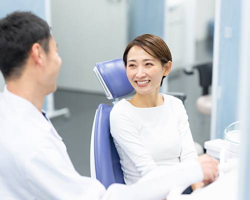 a dentist speaking with a patient