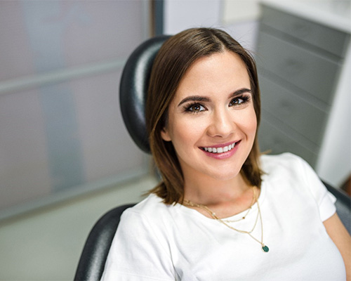 Young woman smiling after wisdom tooth extraction in Bedford, TX