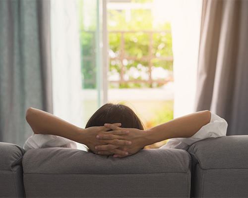 Woman Relaxing at home after wisdom tooth extraction in Bedford, TX