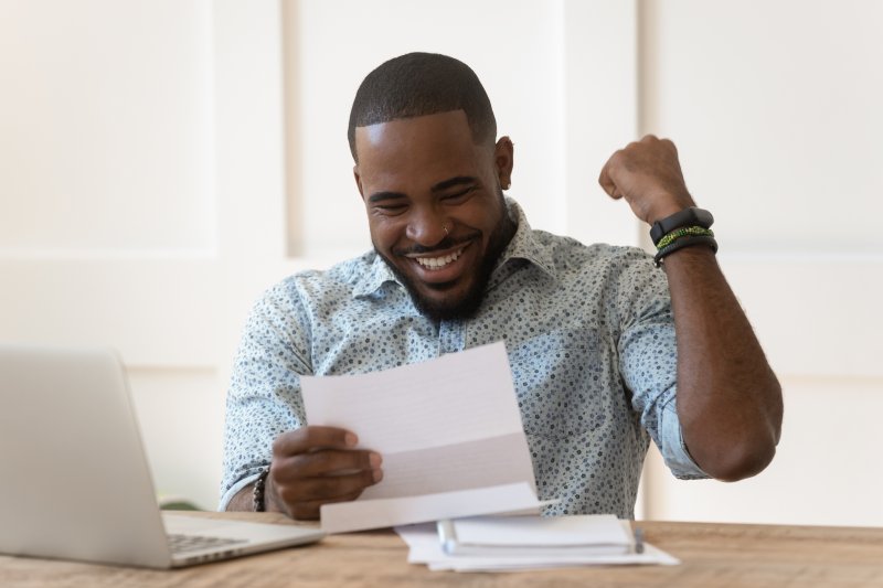 man smiling after receiving tax refund