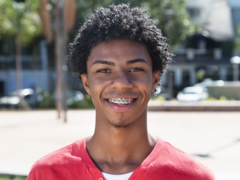 A young man smiling in braces
