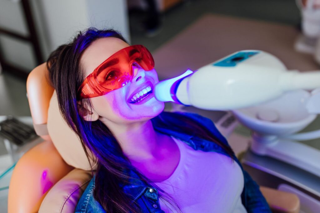 a woman getting a professional tooth whitening treatment